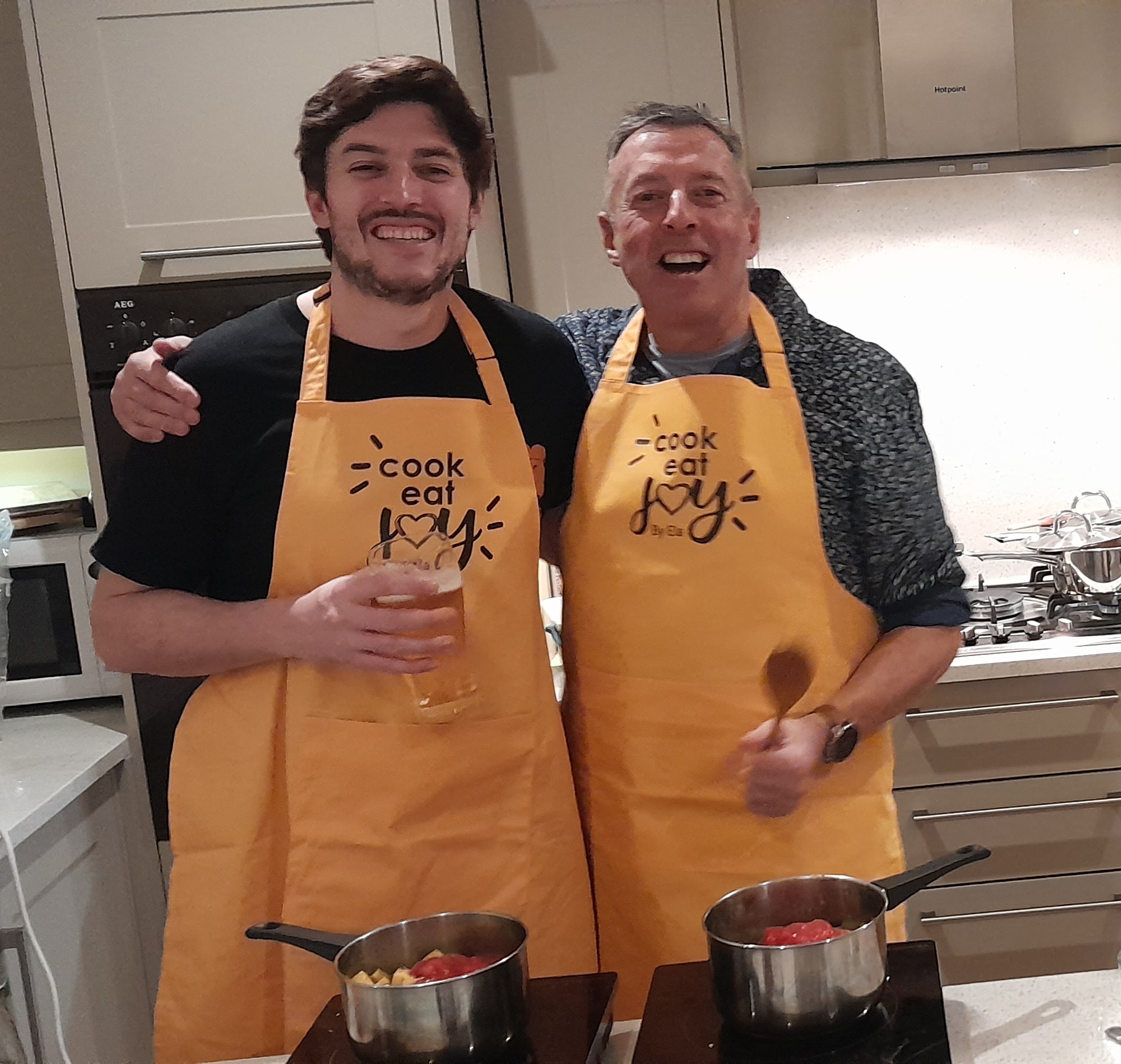 father and son cooking together smiling